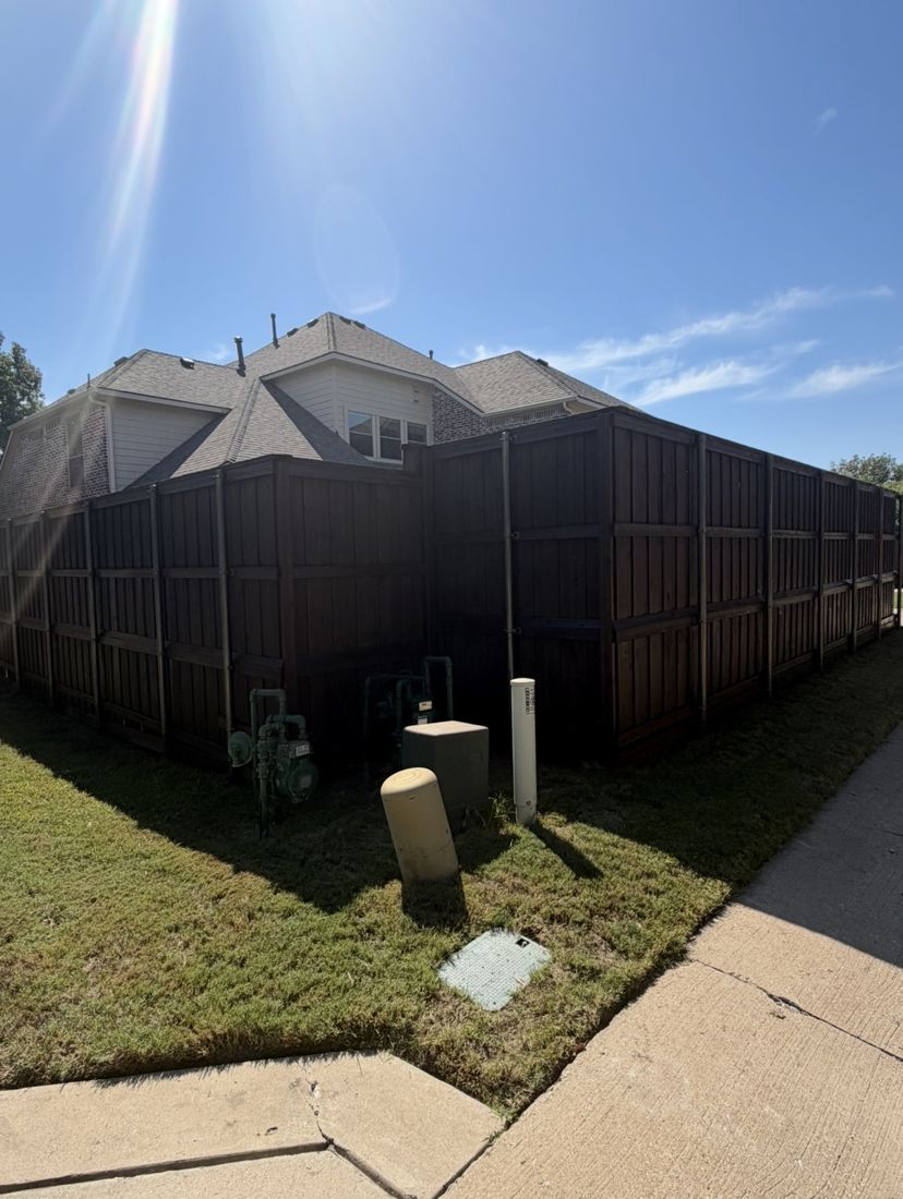 Corner lot fence with steel posts stained dark brown